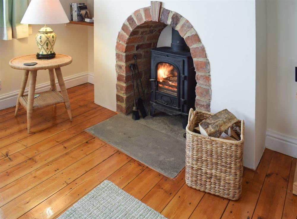Living area with wooden floor and wood burner at Rowan Cottage in Aislaby, near Whitby, Yorkshire, North Yorkshire