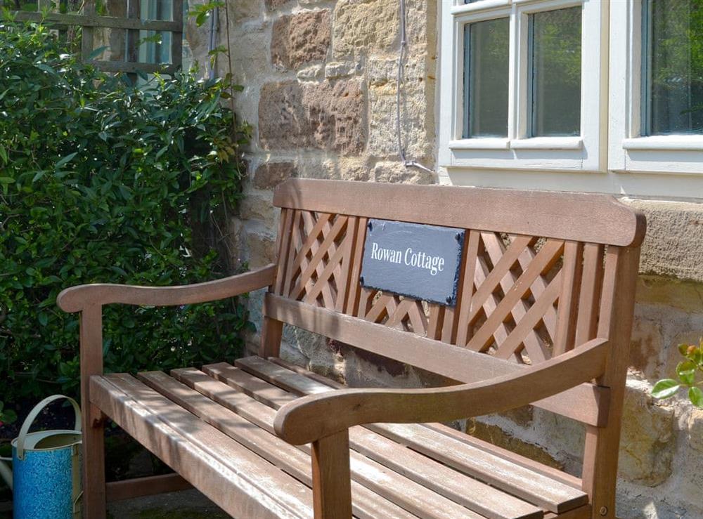 Relax and admire the garden from the front bench at Rowan Cottage in Aislaby, near Whitby, Yorkshire, North Yorkshire