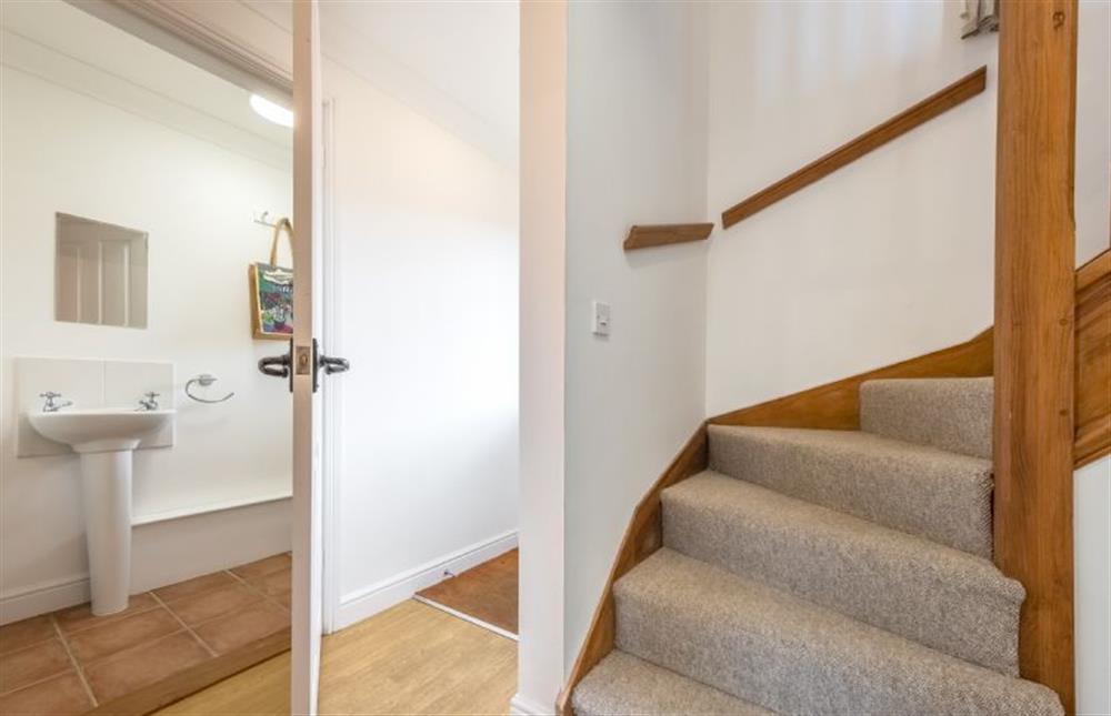 Ground floor: Door to cloakroom and stairs to the first floor at Rowan Cottage, Holt