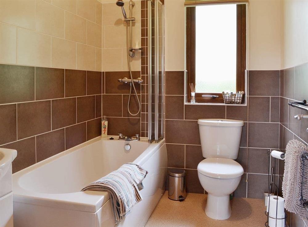 The bathroom features a shower over the bath at Rowanburn Lodge in Greystoke, near Penrith, Cumbria