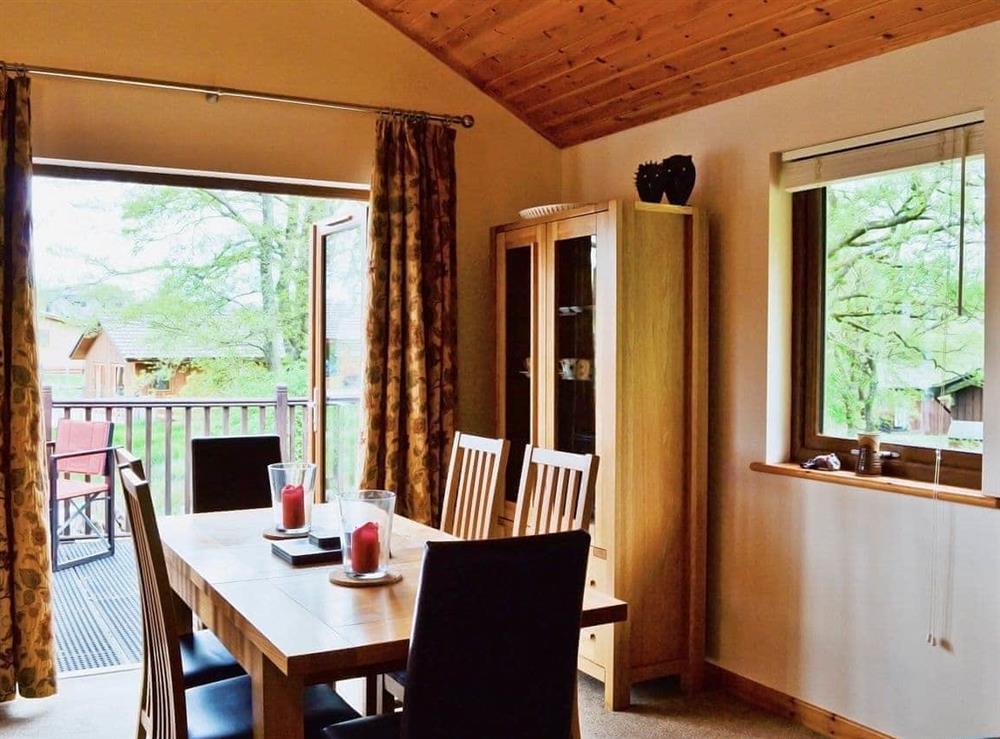 The dining table is next to a set of patio doors that open onto the terrace at Rowanburn Lodge in Greystoke, near Penrith, Cumbria