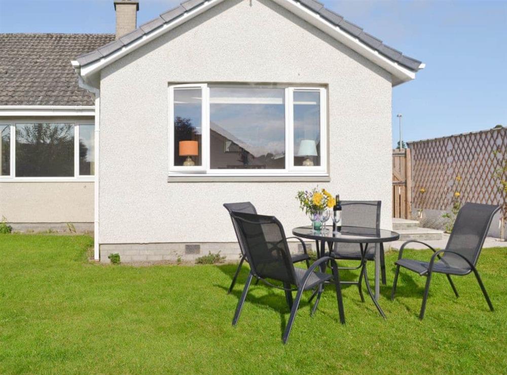 Rear garden and sitting-out-area at Rowanlea Cottage in Nairn, Morayshire