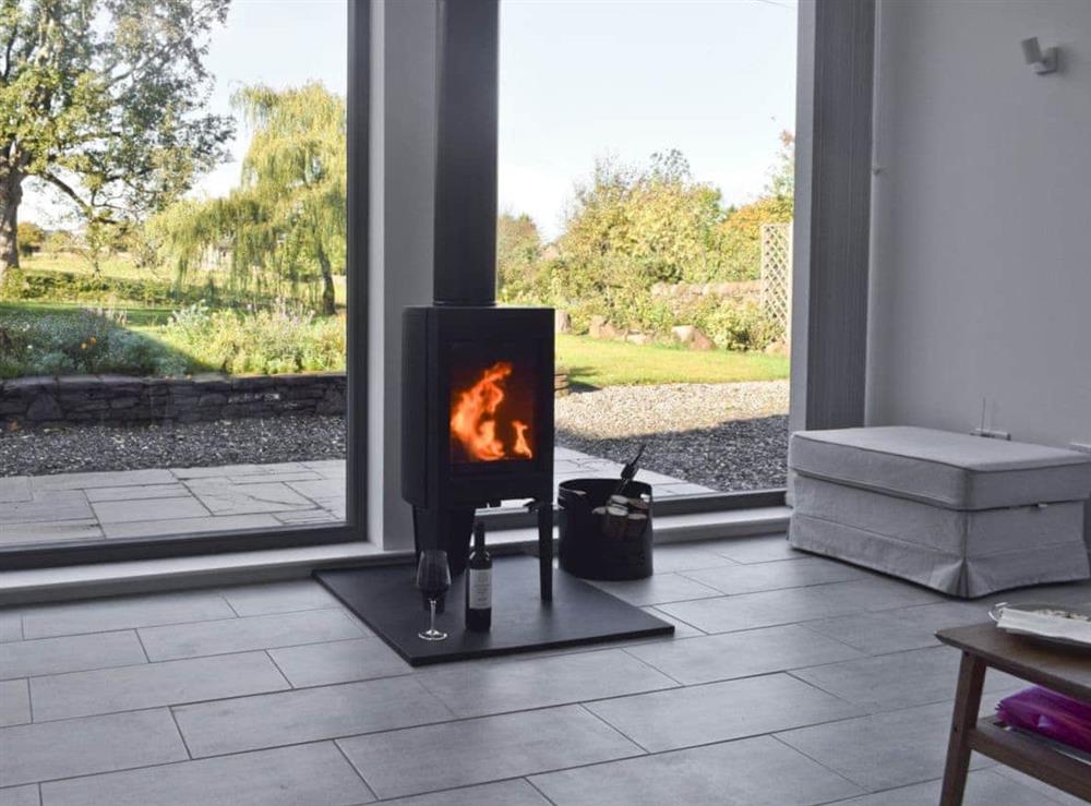 Contemporary living space with wood burner & views of the garden at Rowanlea in Muthill, near Crieff, Perthshire