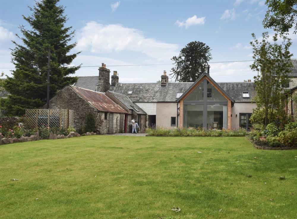Large lawned garden with sitting-out area, garden furniture and BBQ at Rowanlea in Muthill, near Crieff, Perthshire