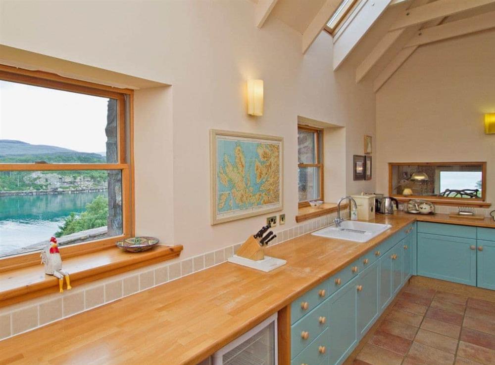 Modern fitted kitchen with breakfast bar area and ceramic tiled floor (photo 2) at Rubha Lodge in Shieldaig, Wester Ross., Ross-Shire