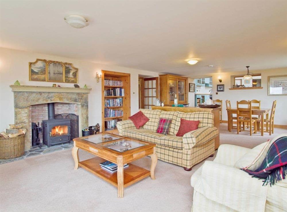 Spacious living/dining room with wood-burning stove and sea views (photo 5) at Rubha Lodge in Shieldaig, Wester Ross., Ross-Shire