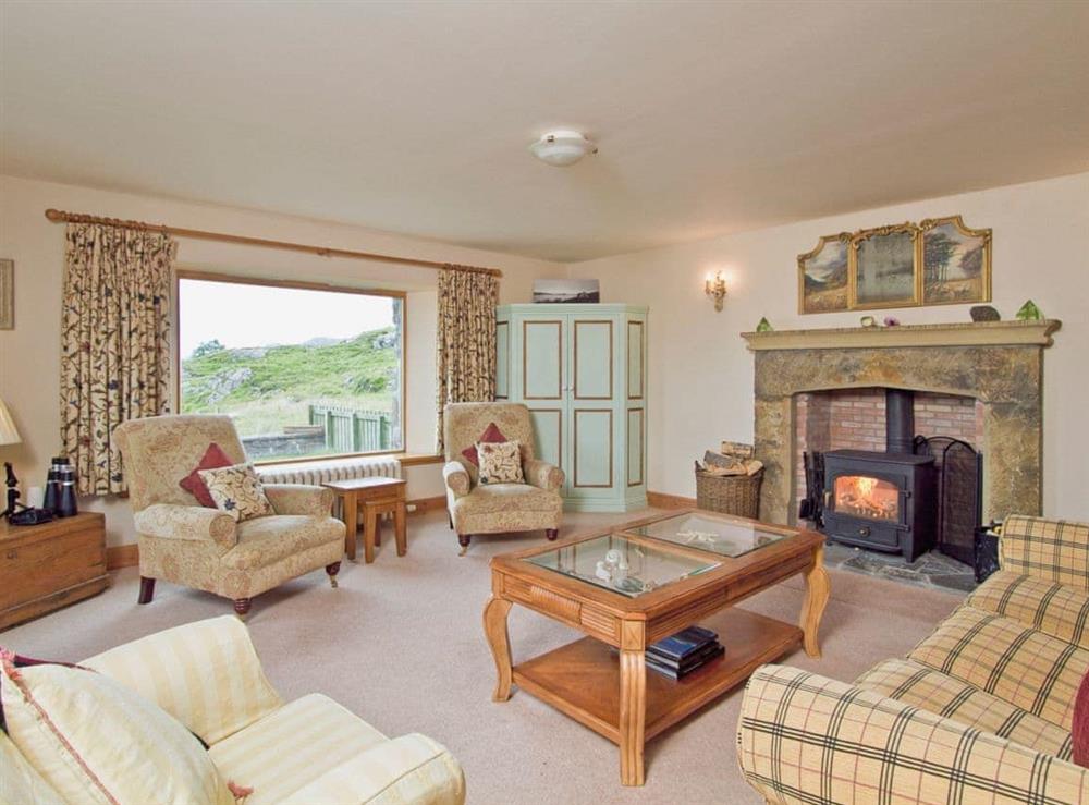 Spacious living/dining room with wood-burning stove and sea views at Rubha Lodge in Shieldaig, Wester Ross., Ross-Shire