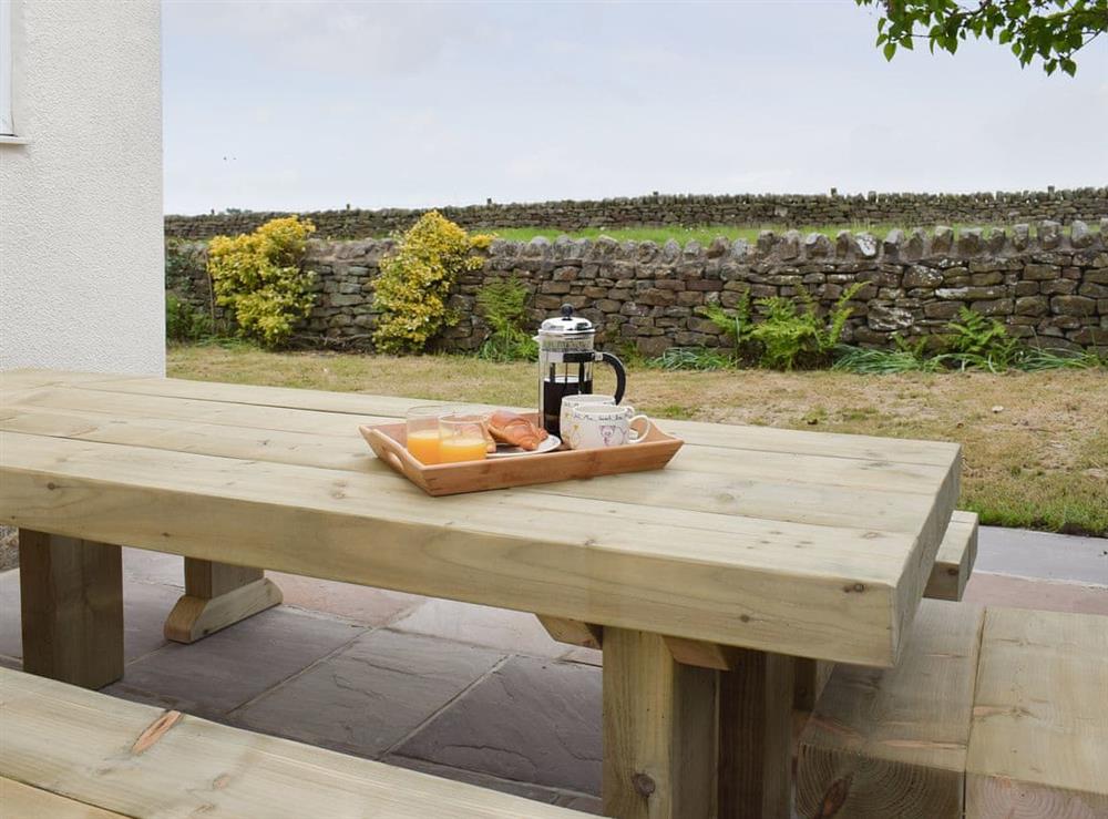 Paved patio area with outdoor furniture at Rudda Farm Cottage, 