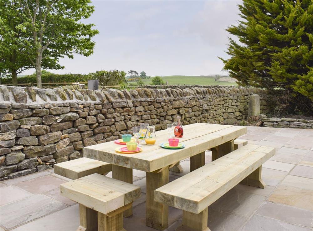 Paved patio area with outdoor furniture at Rudda Farm House, 