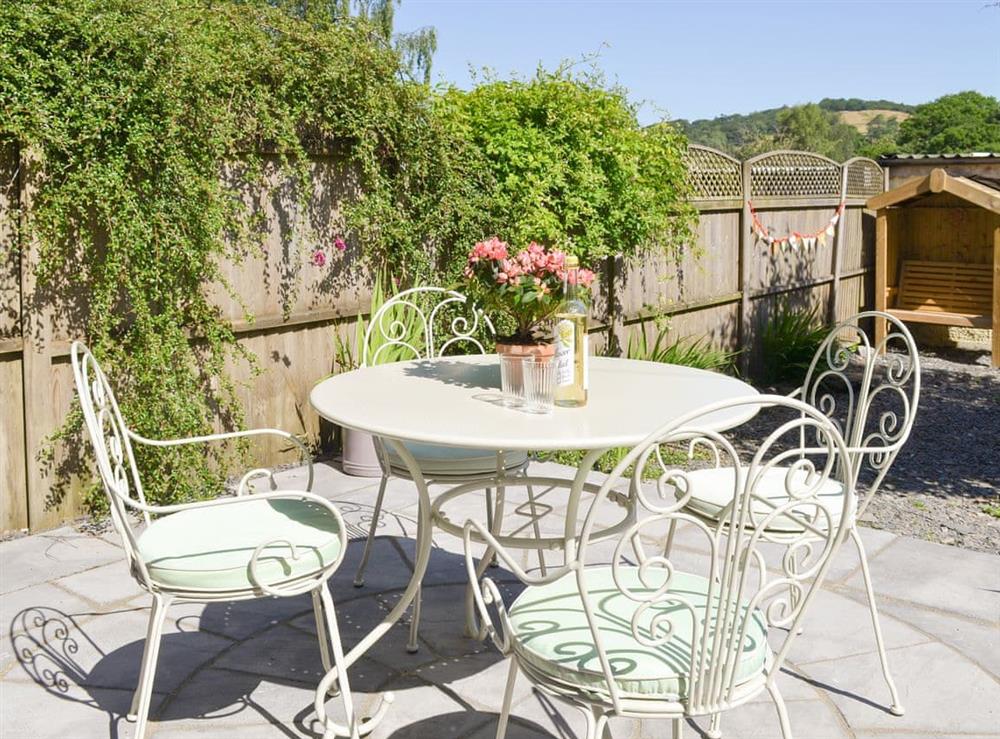 Courtyard garden with patio area at Running Hare in Windermere, Cumbria