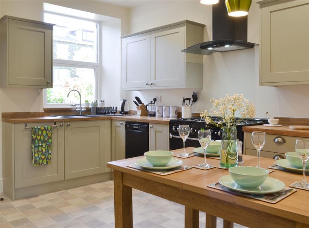 Well-equipped kitchen with dining area at Running Hare in Windermere, Cumbria