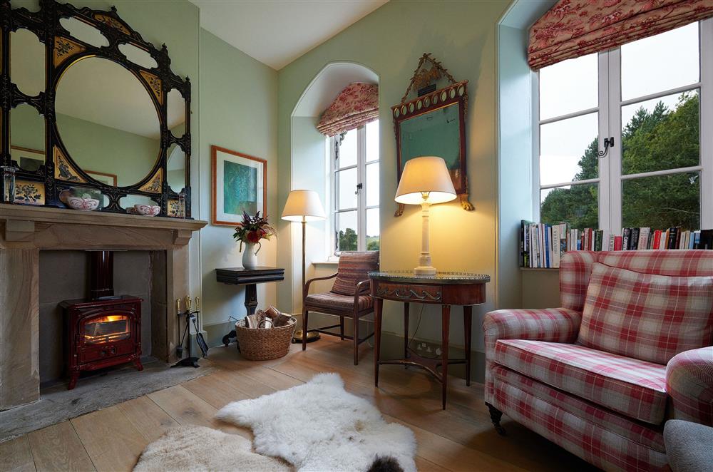 The cosy sitting room boasts a wood burning stove at Russian Cottage, Chatsworth Estate, Nr Matlock 
