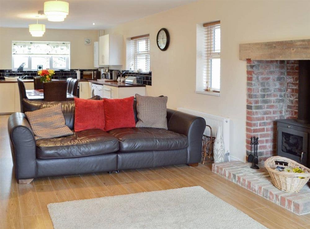 Cosy open plan living/dining room/kitchen with wood burner at Ryandale in Longhirst, near Morpeth, Northumberland