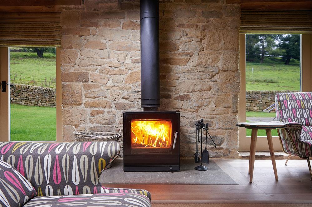 Enjoy the views whilst relaxing in-front of the wood burning stove  at Rye Croft Cottage, Chatsworth Estate, Nr Matlock 