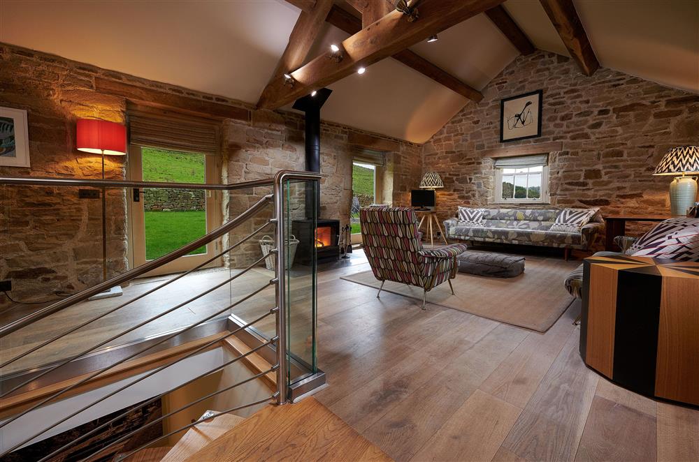 The sitting area boasts beautiful views and exposed beams  at Rye Croft Cottage, Chatsworth Estate, Nr Matlock 