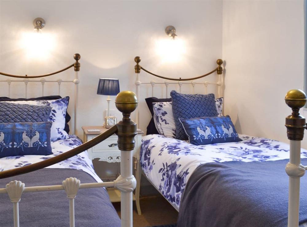 Pretty twin bedroom at Sage Cottage in St Columb Major, Cornwall
