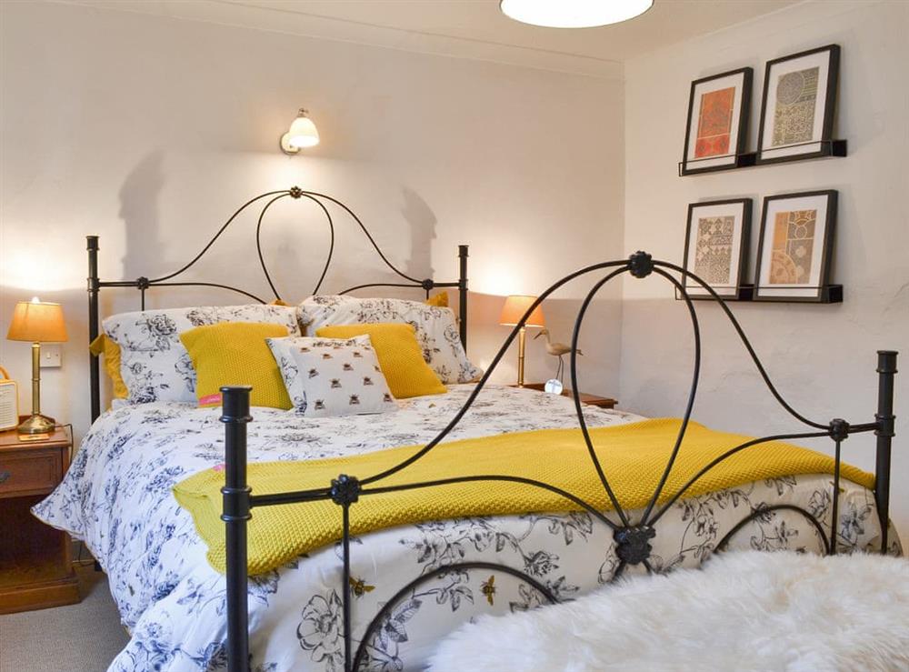 Romantic double bedroom with antique style bed at Sage Cottage in St Columb Major, Cornwall