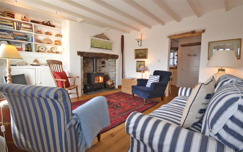 The cosy sitting room with woodburner. at Sail Cottage in Beesands