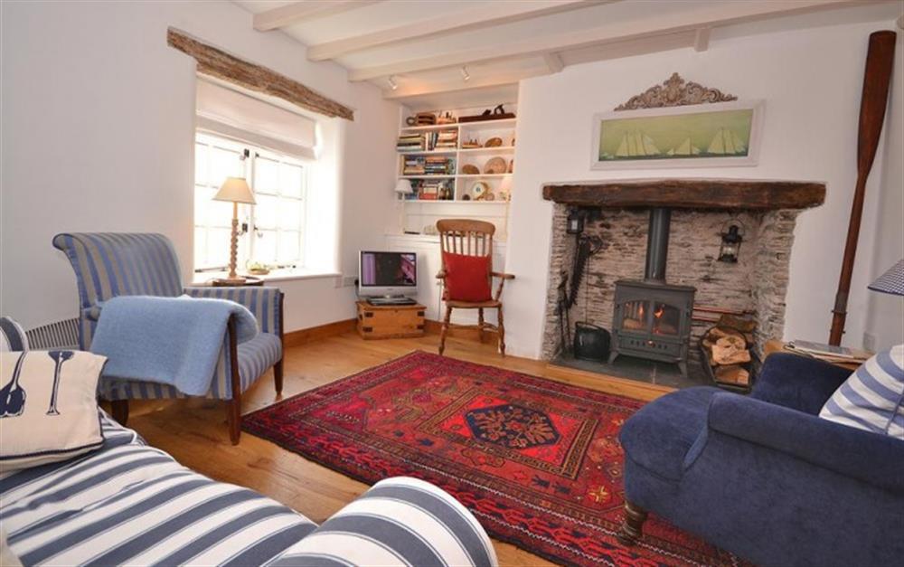 The sitting room and woodburner. at Sail Cottage in Beesands
