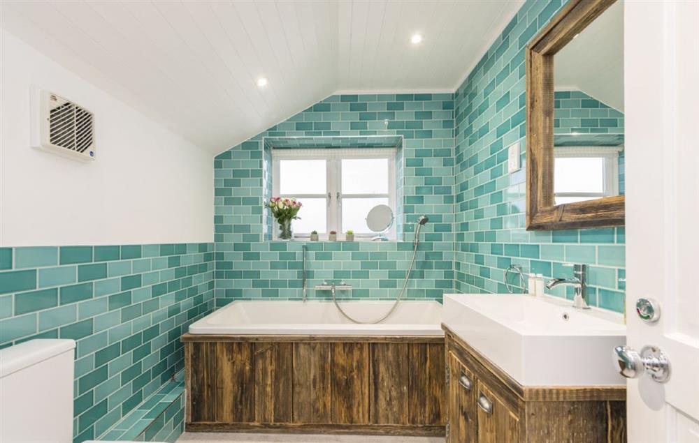 Bathroom with bath and separate shower at Sally Port Cottage, St Anthonys Lighthouse