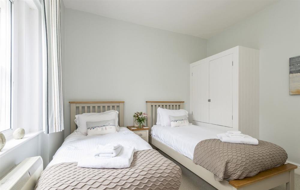 Bedroom with twin 3 single beds at Sally Port Cottage, St Anthonys Lighthouse