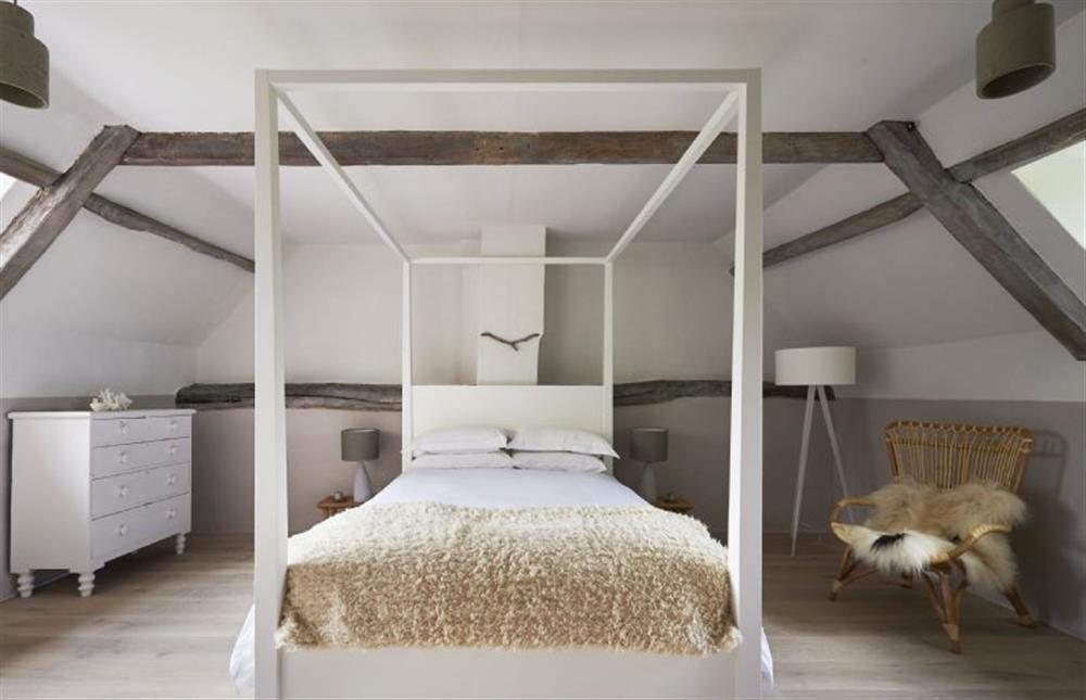 Large double aspect bedroom with four-poster king size bed at Salt, Sharrington near Melton Constable