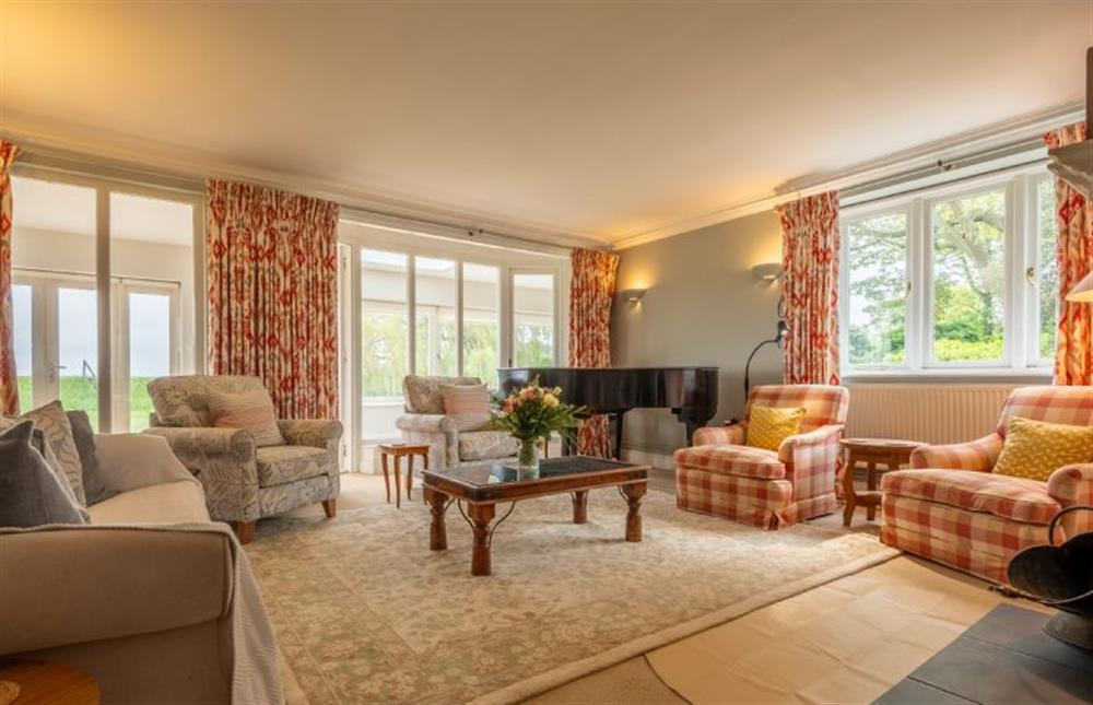 Sitting room with comfortable seating and piano