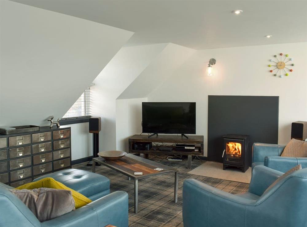 Stylishly furnished living room with wood burner at Saltlife Cottage in Port William, Wigtownshire