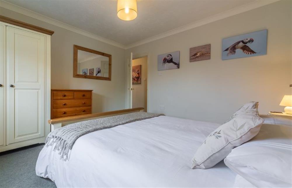 First floor: Bedroom two has king-size bed and marsh views at Saltmarshes, Holme-next-the-Sea near Hunstanton