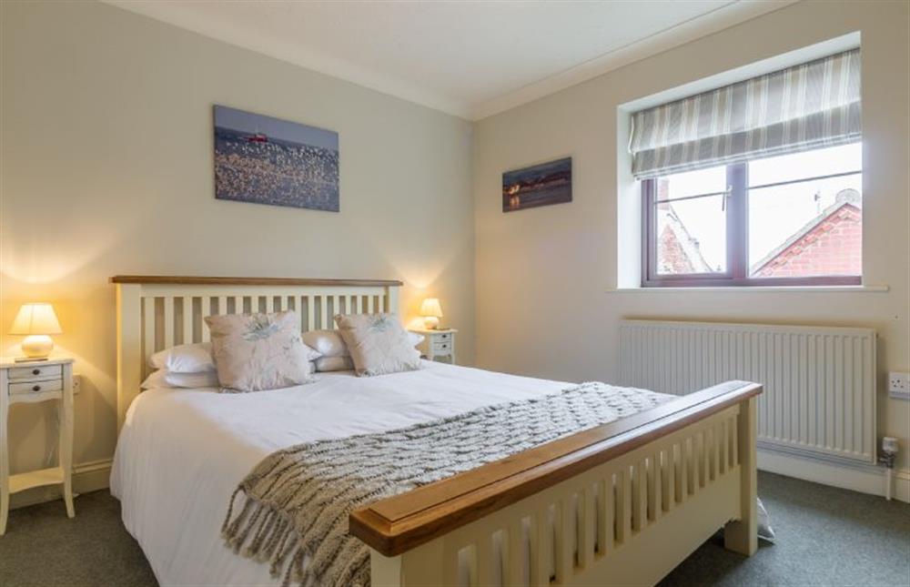 First floor: Bedroom two has king-size bed at Saltmarshes, Holme-next-the-Sea near Hunstanton