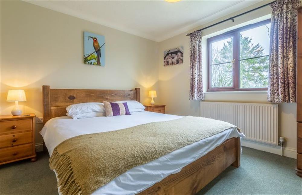 First floor: Master bedroom has super king-size bed at Saltmarshes, Holme-next-the-Sea near Hunstanton