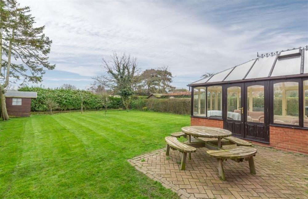 The garden ifs fully enclosed, with lawn and patio area at Saltmarshes, Holme-next-the-Sea near Hunstanton
