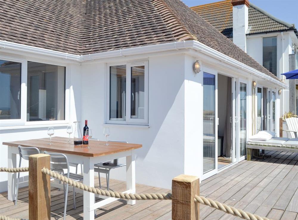 Decked patio with a range of outdoor furniture at Salty Lodge in Hayling Island, Hampshire