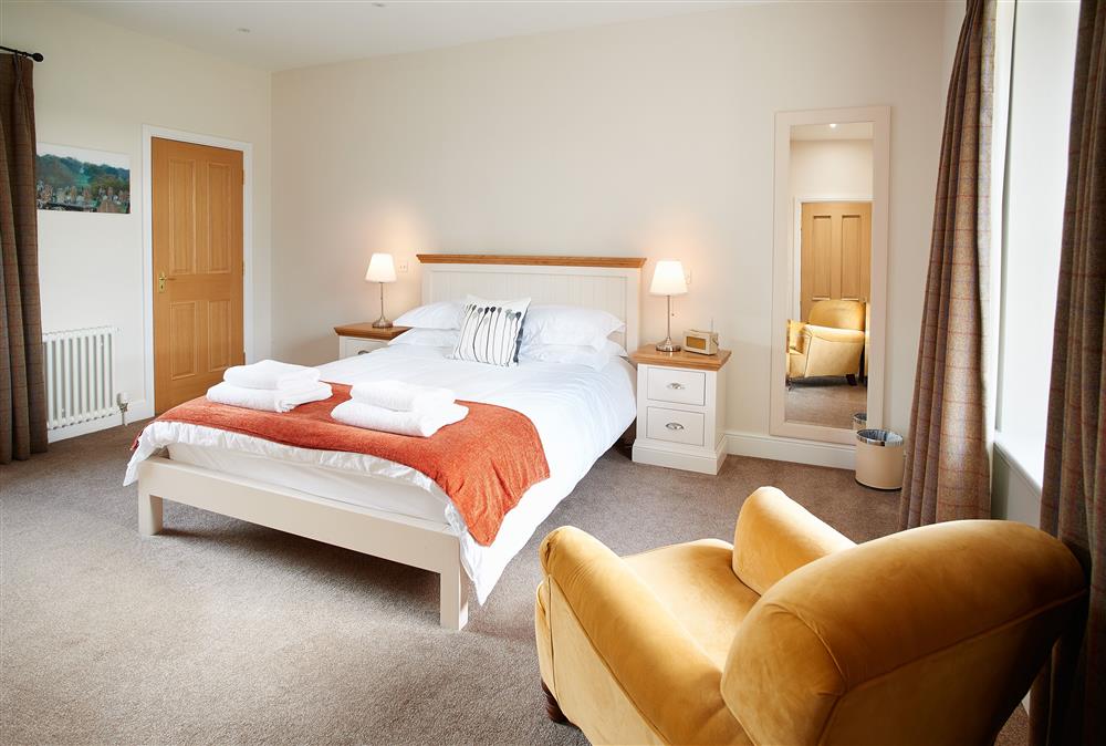 Bedroom with a 5’ king-size bed at Salutation Apartment, Netherby Hall, Longtown