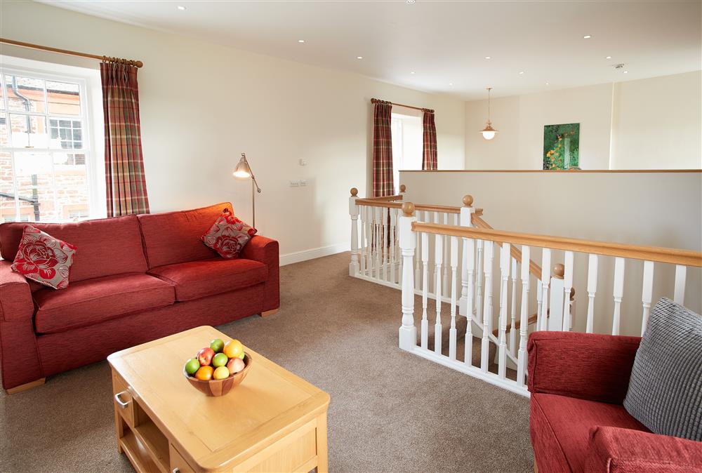 Comfortable sitting area for guests to relax in at Salutation Apartment, Netherby Hall, Longtown