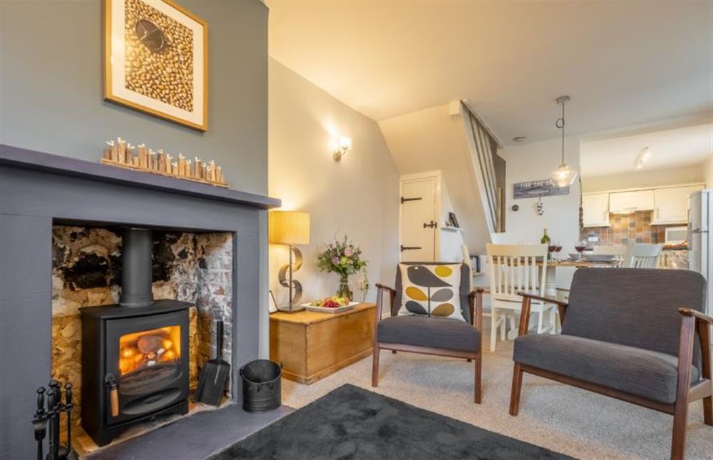 Samphire Cottage: Cosy sitting room featuring a log burner  at Samphire Cottage (BS), Brancaster Staithe near Kings Lynn