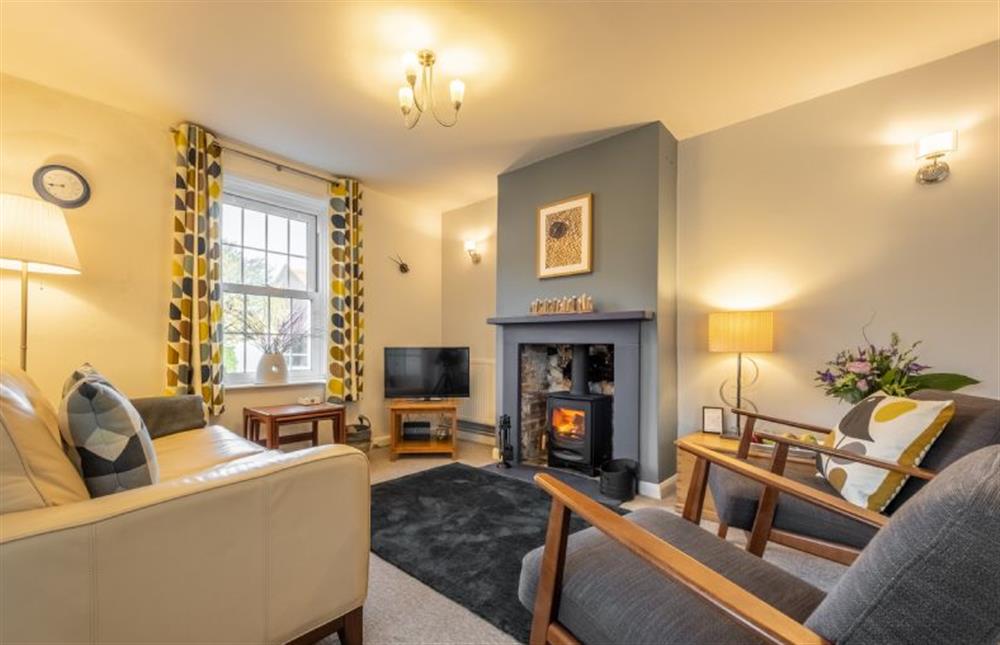 Samphire Cottage: Sitting room featuring a log burner and plenty of seating