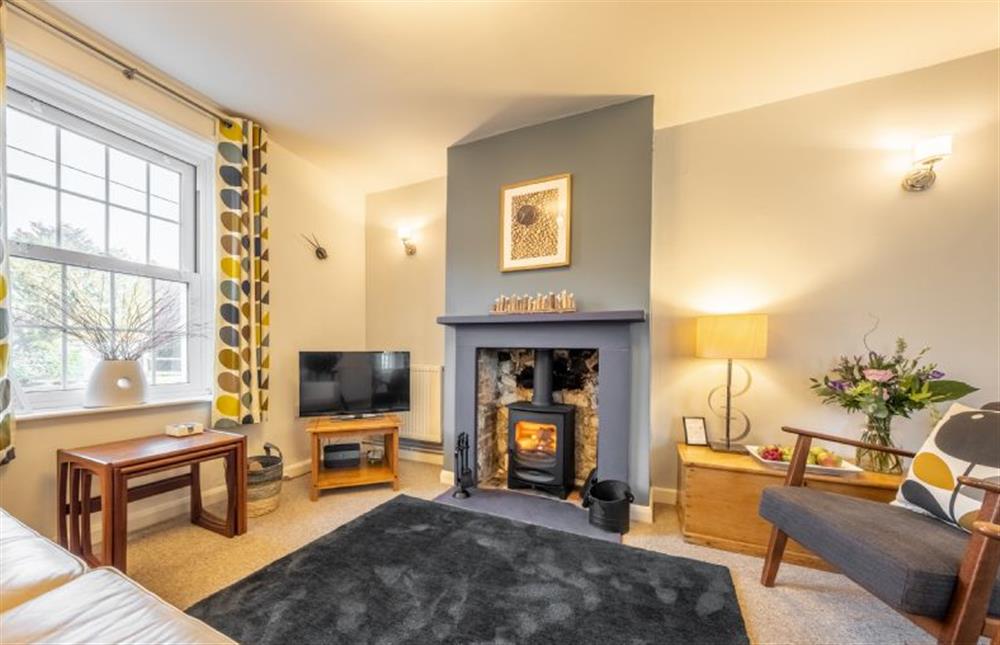 Samphire Cottage: Sitting room featuring a log burner and plenty of seating