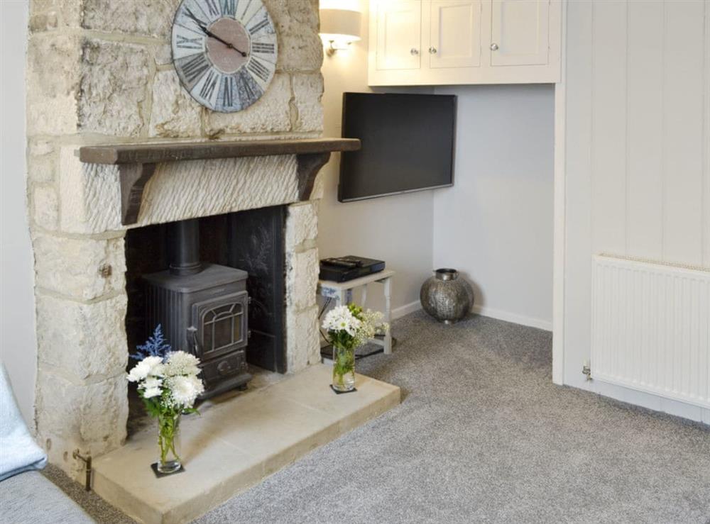 Feature fireplace within living room at Samphire Cottage in Fortuneswell, near Portland, Dorset