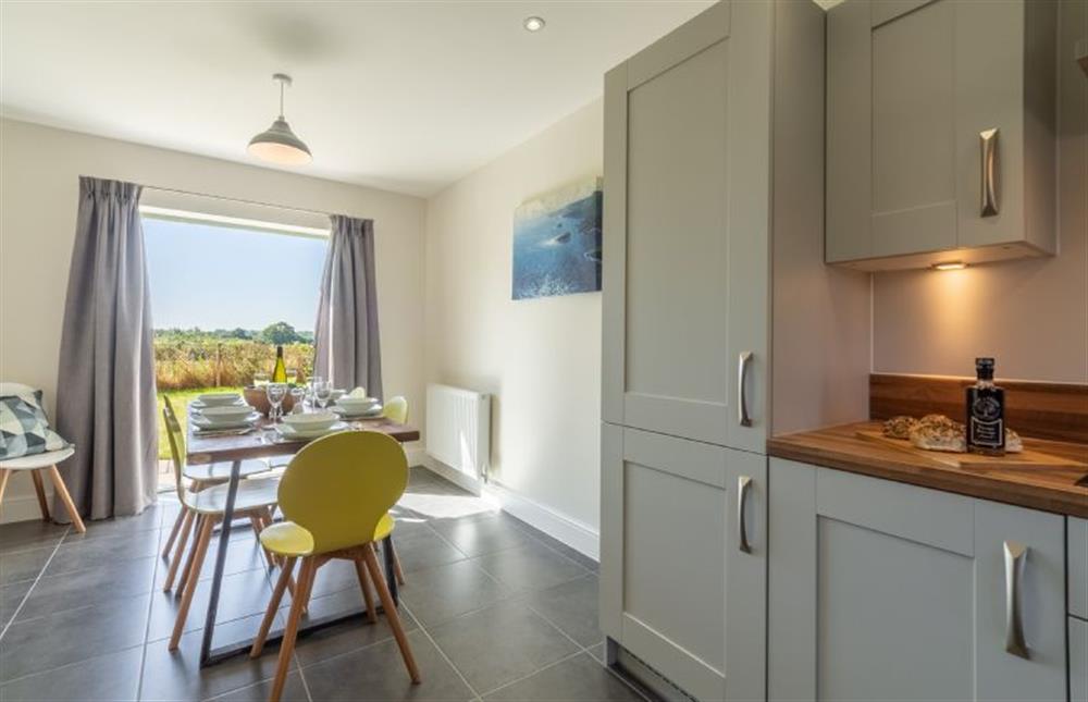 Ground Floor: Dining area with doors to the garden at Samphire House, Bodham near Holt