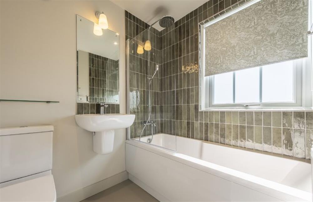 Master bathroom with bath and shower over at Sandbank, Hunstanton