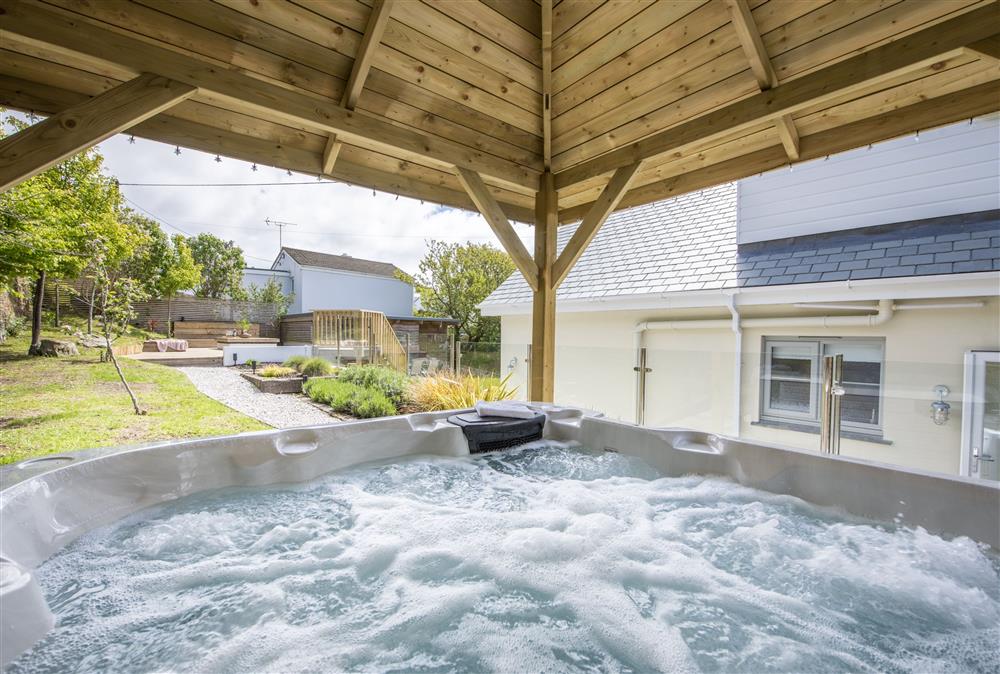Soak away the day and unwind in the hot tub at Sandbrook, St Agnes