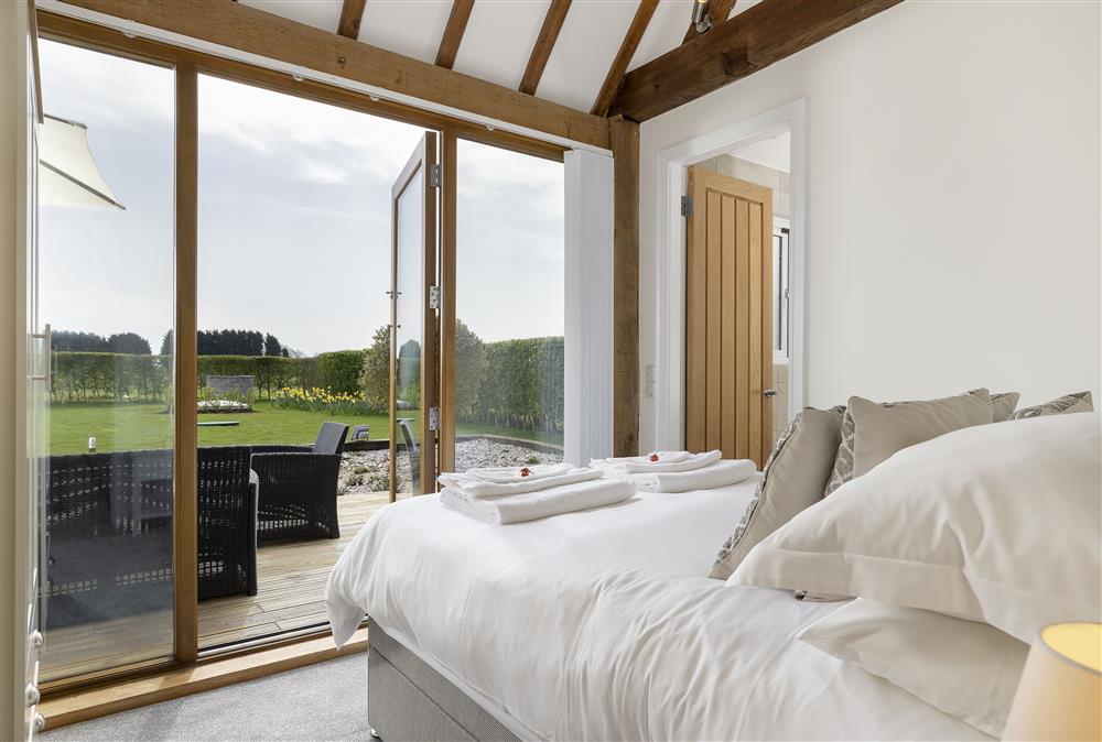 Second bedroom with 4’6 bed and en-suite shower room at Sandfields Barn, Luddington
