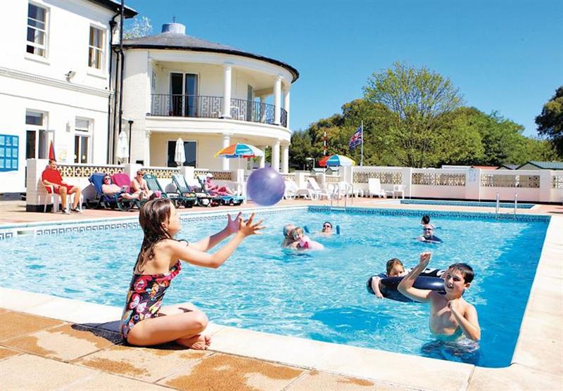 Outdoor heated swimming pool at Sandhills Holiday Park in Dorset, South West of England