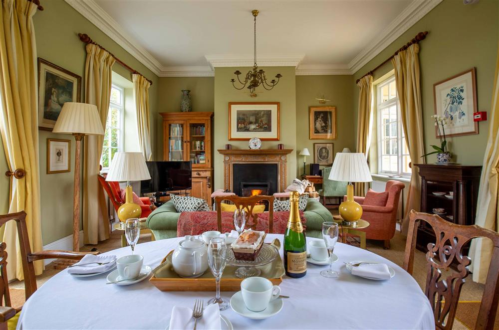 The dining area with table seating four guests  at Sandown Cottage, Bruern, near Chipping Norton