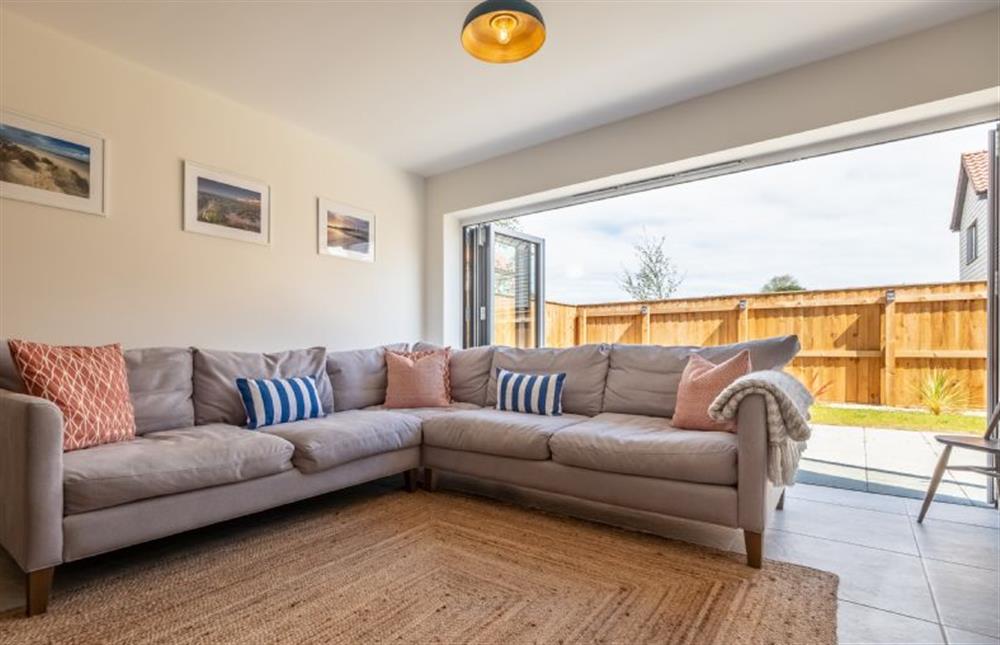 Comfortable sofa seating beside the bi-fold doors at Sandpiper House, Ingoldisthorpe near Kings Lynn