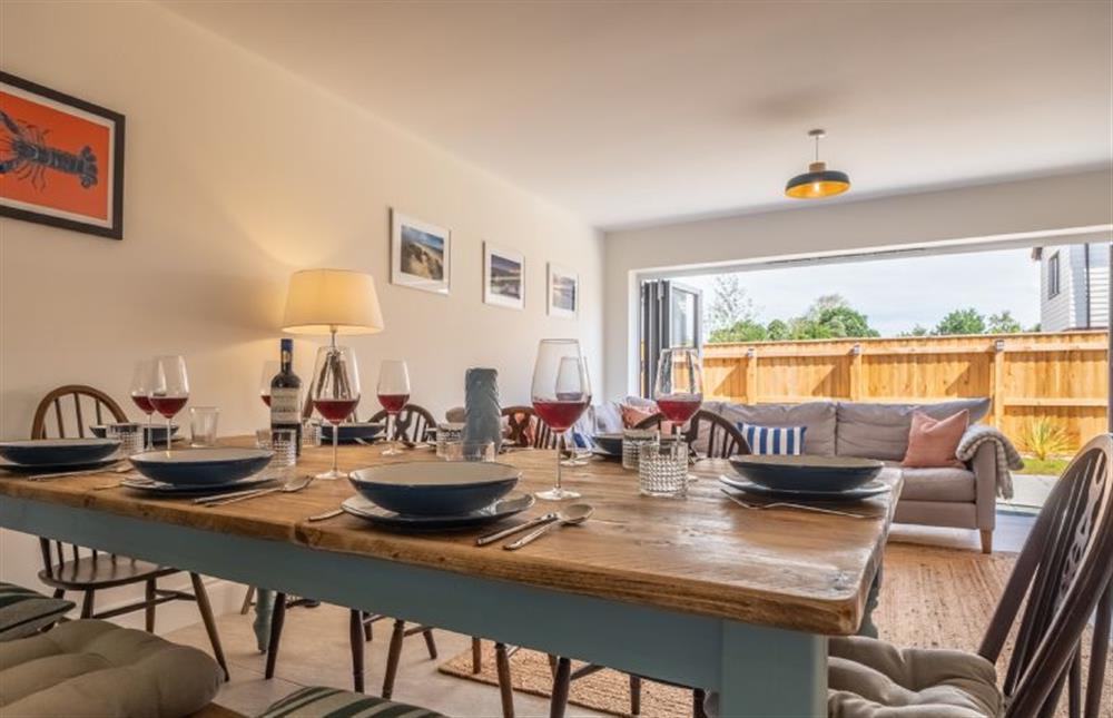 Dining table with bench and chair seating (photo 2) at Sandpiper House, Ingoldisthorpe near Kings Lynn