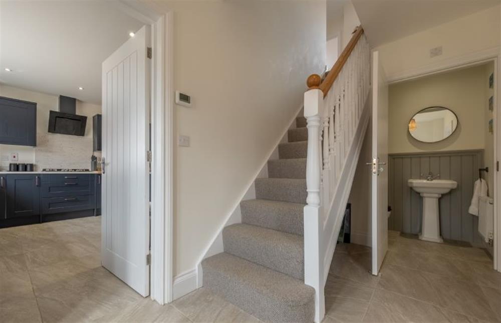 Hallway with stairs to the first floor and cloakroom at Sandpiper House, Ingoldisthorpe near Kings Lynn