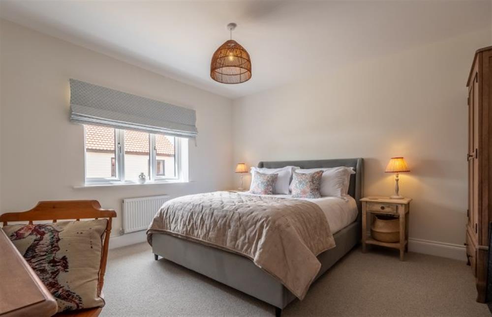 The master bedroom with 5’ king-size bed at Sandpiper House, Ingoldisthorpe near Kings Lynn