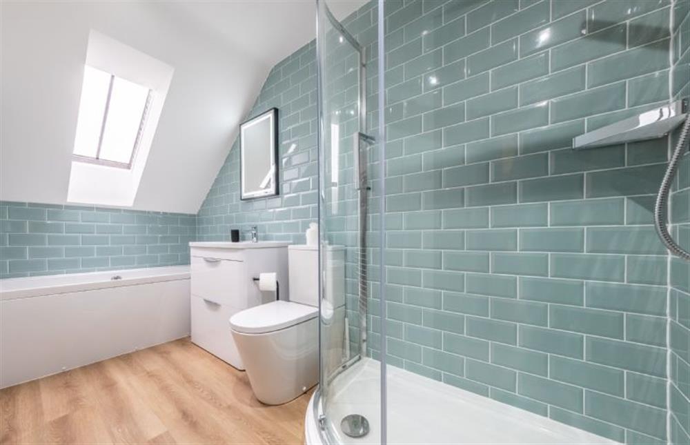 A fully tiled bathroom with bath and shower options at Sandpiper Lodge, Great Walsingham